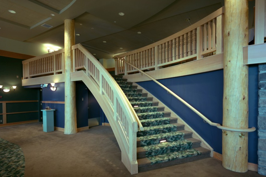 Curved wood staircase with landing